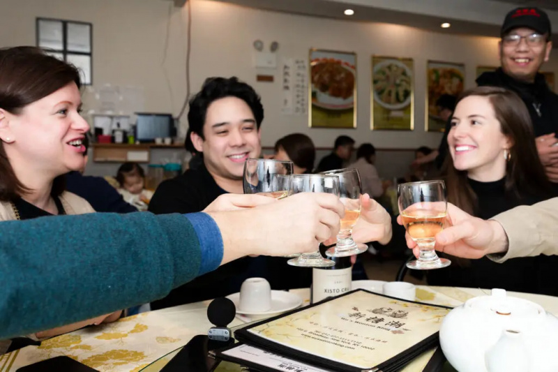 Skupina Somm's toasting with wine at Wu's Wonton King