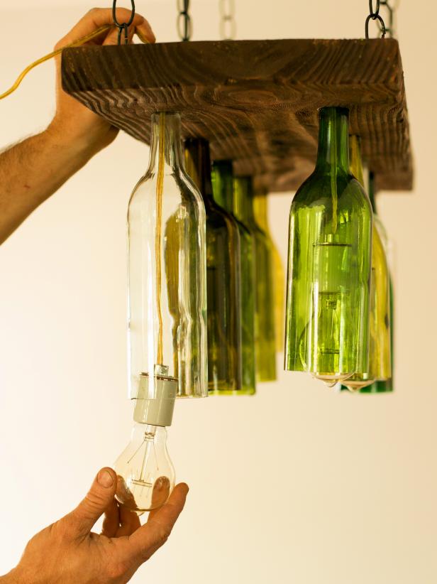 Orginal-Chandelier-Made-From-Wine-Bottles_inserting-the-bottles_3x4