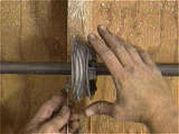 पहिया को घुमाएं ताकि दरवाजे की तरफ से चरखी पर ढीला खींच लिया जाए। पहिया को हैडर ब्रैकेट में स्लाइड करें, और इसे सुरक्षित रूप से कस लें (छवि 2)।